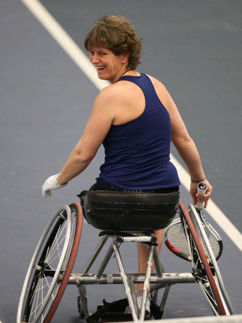 a female wheelchair tennis player on the court