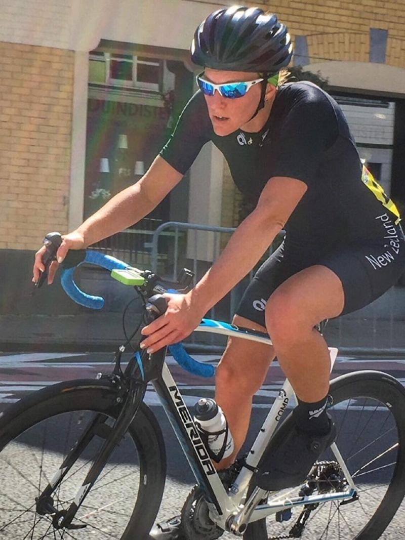 a female Para cyclist comes round a road bend