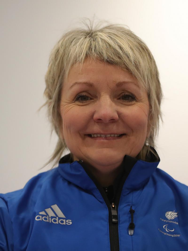 a female wheelchair curler smiles for the camera