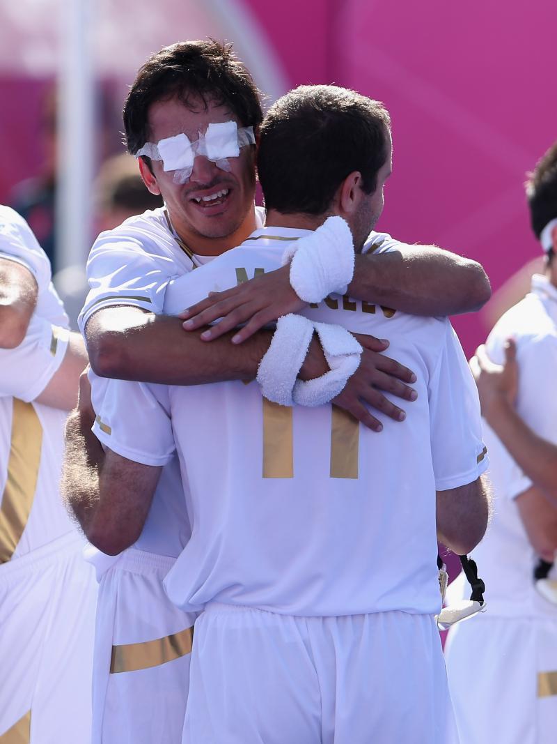 a group of blind footballers hugging eachother