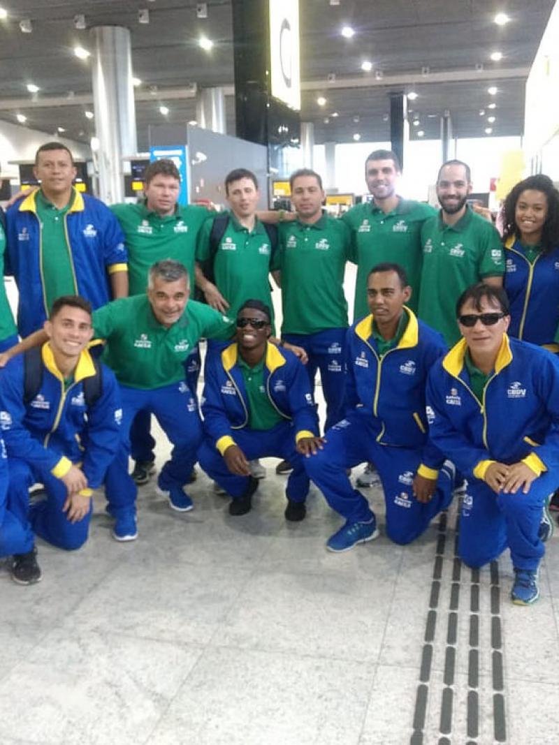 A group of blind footballers smiling in an airport
