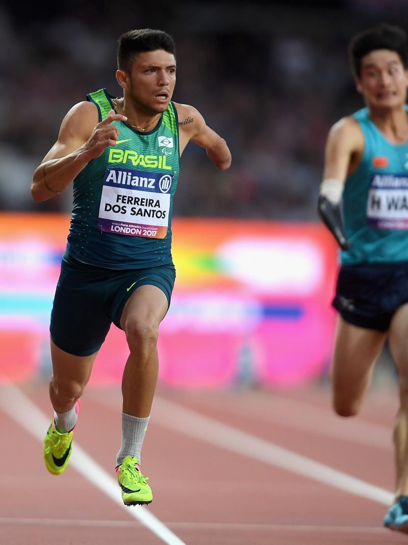 a male Para sprinter crosses the finish line