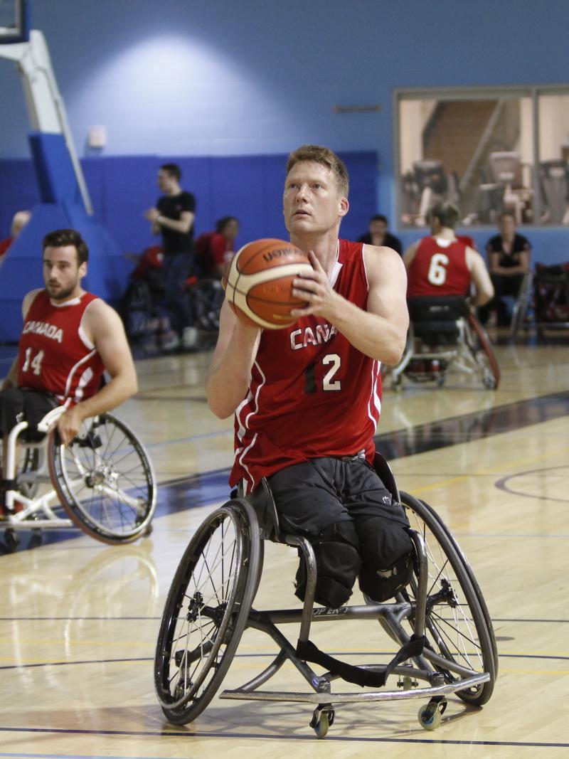 a male wheelchair basketballer goes to take a shot