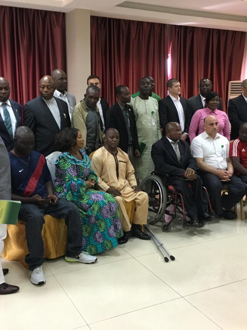 a group of men and women sitting and standing