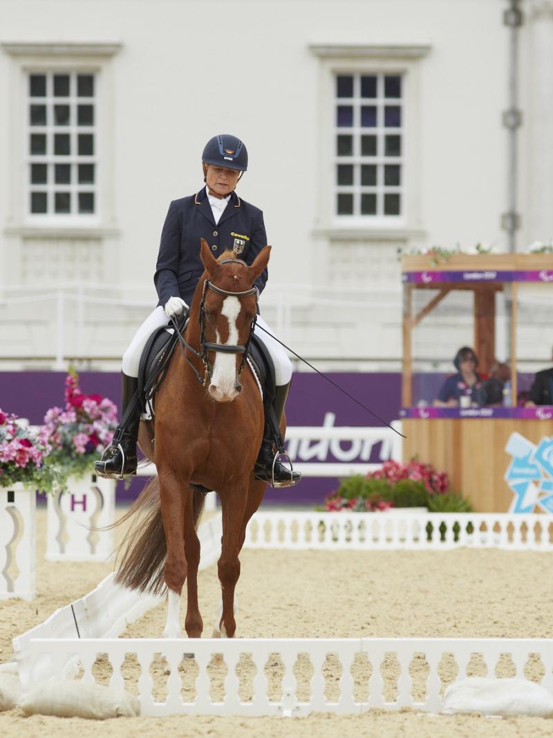 a female Para equestrian rider on her horse performing dressage