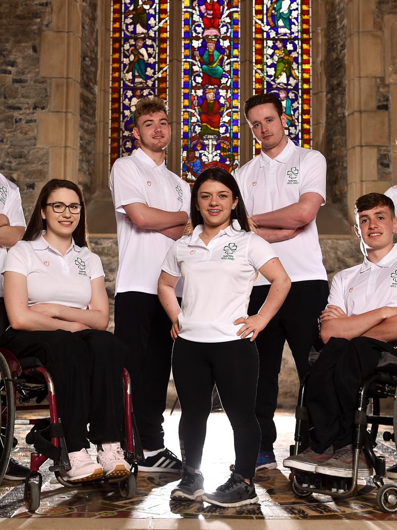a group of Para athletes sitting and standing