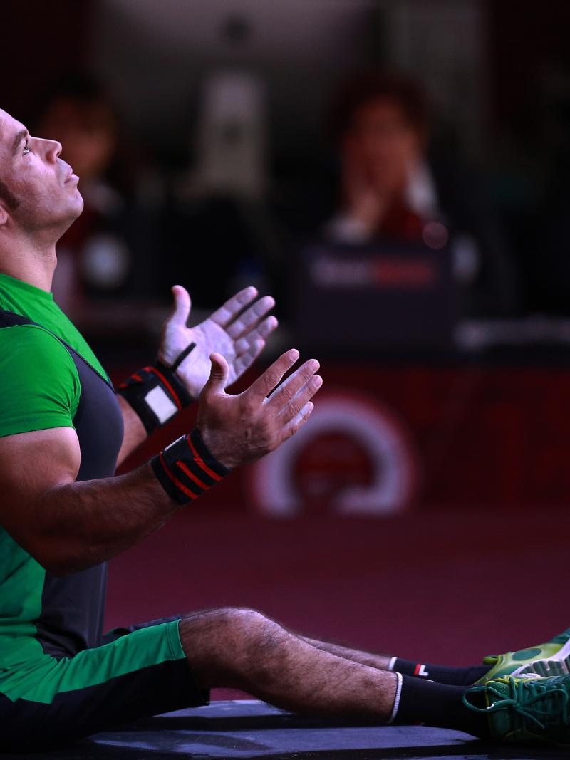 a male powerlifter prepares on the bench