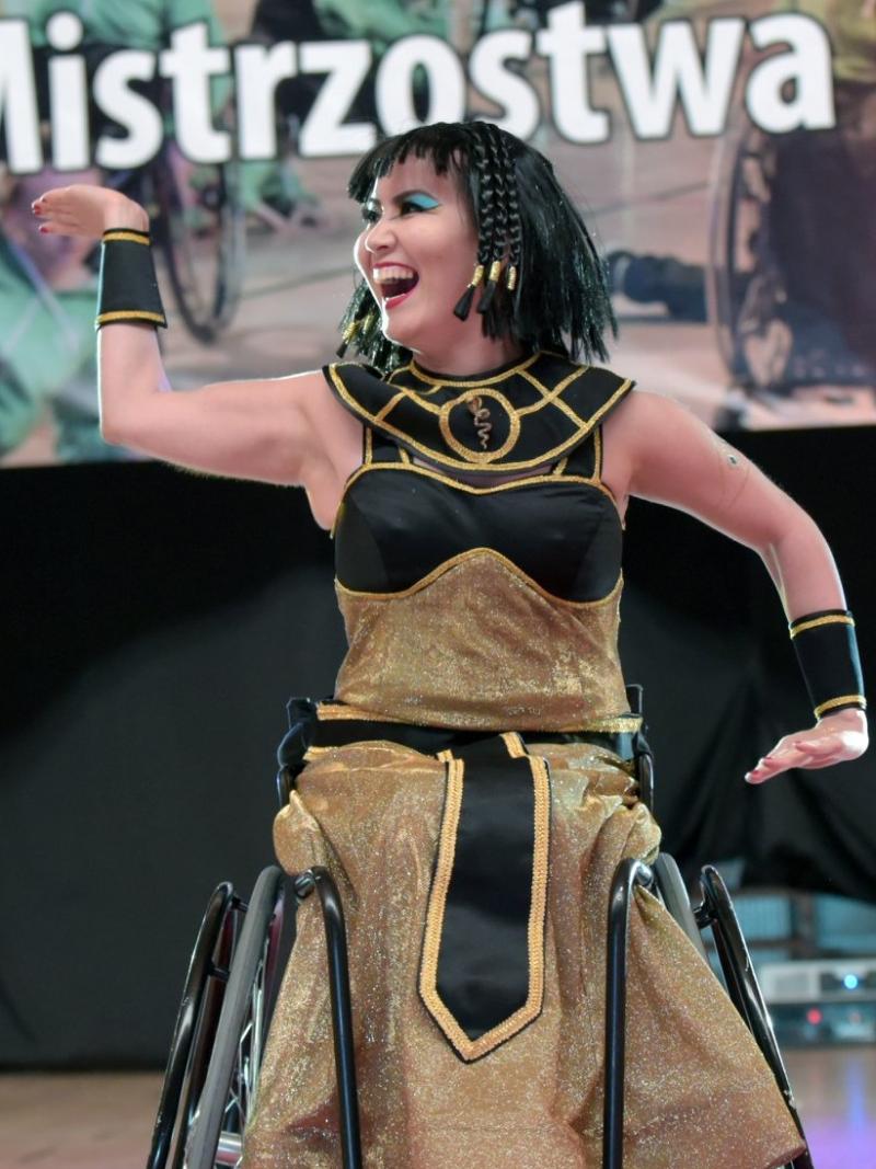 a female Para dance sport athlete strikes a pose dressed as Cleopatra