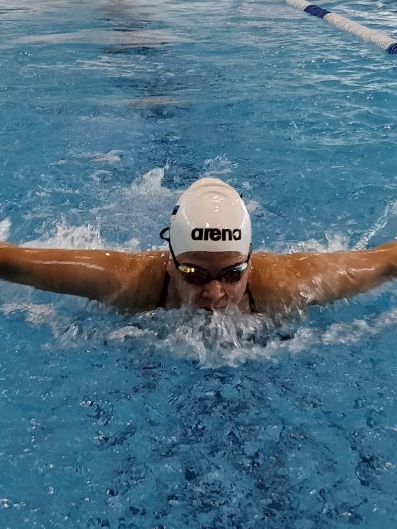 a female Para swimmer mid-stroke