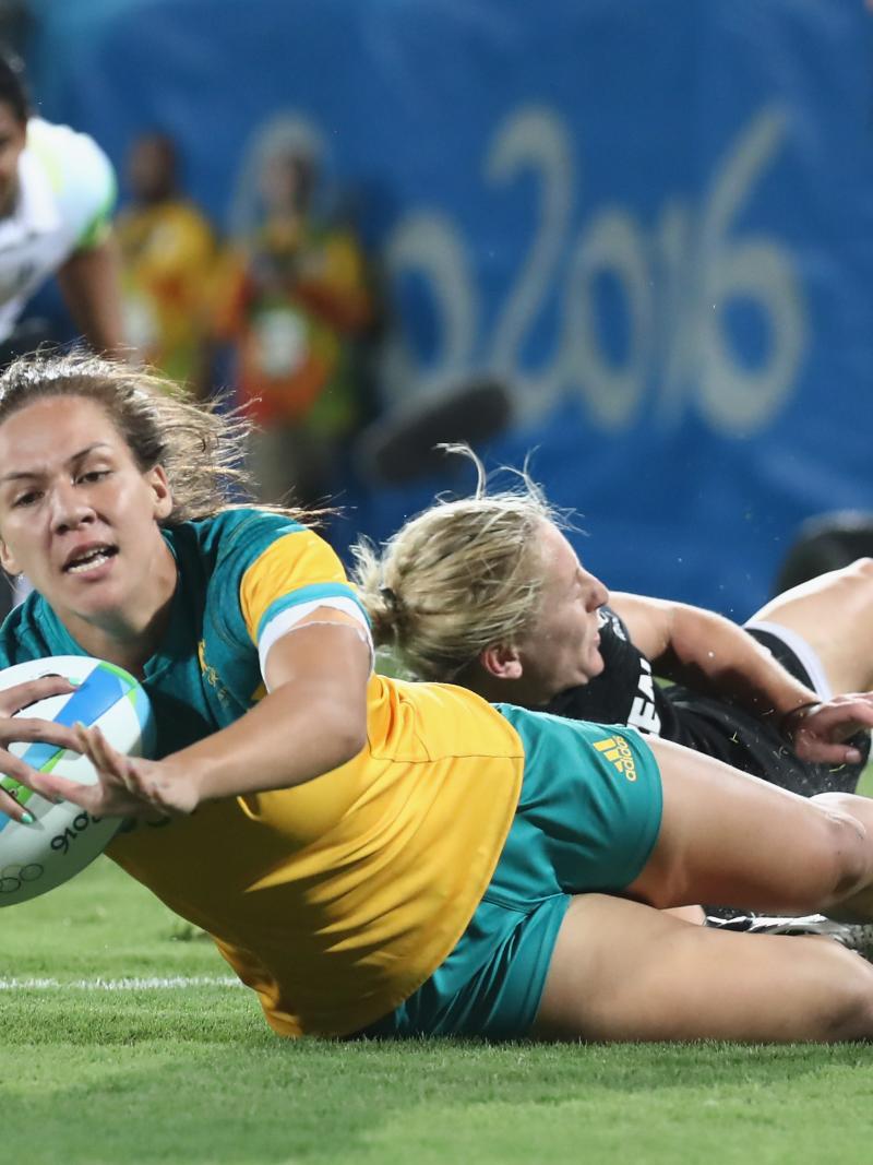 a female rugby player scores a try
