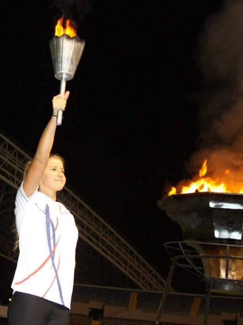 a female Para athlete lighting a cauldron