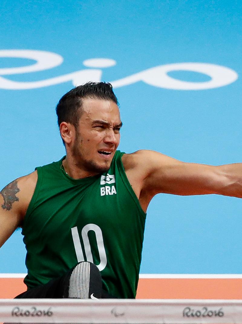 a male sitting volleyball player spikes the ball