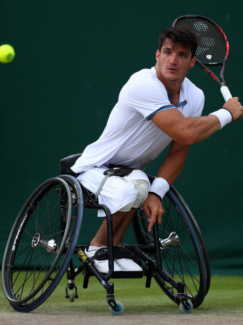 Argentinian male wheelchair tennis player hits a  a backhand shot