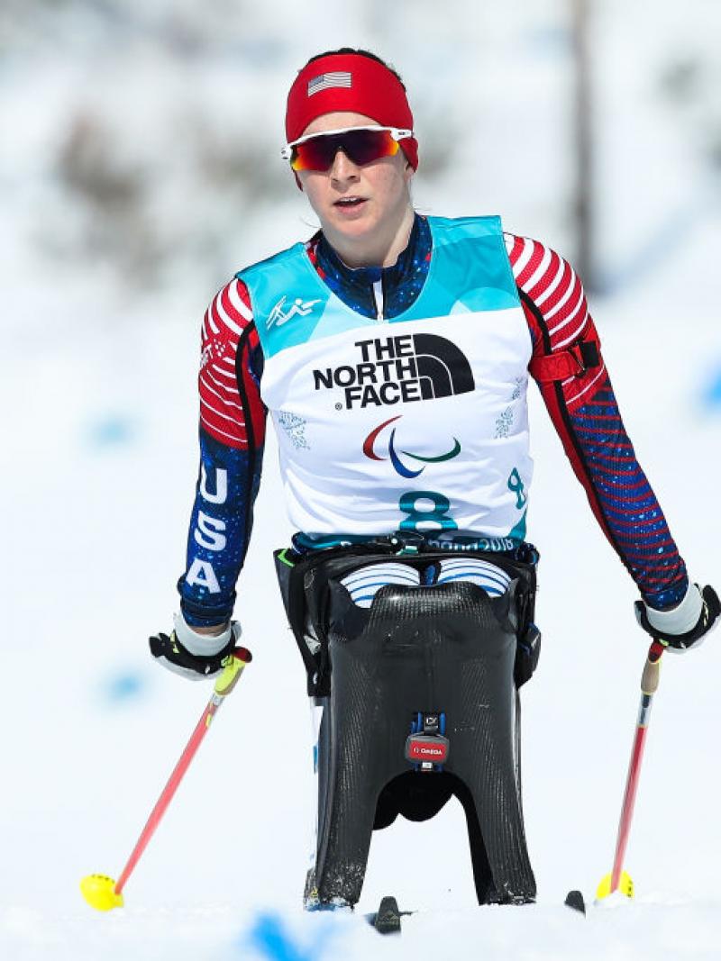 US female Nordic skier pushes on the snowy course