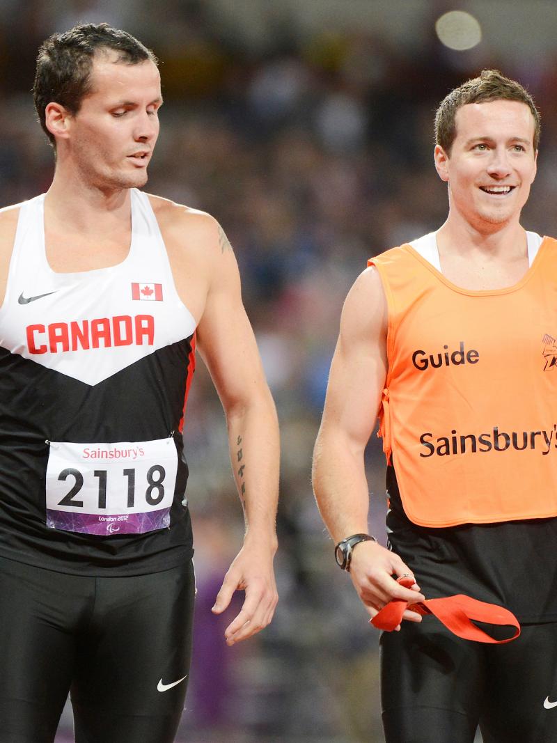 Vision impaired sprinter alongside his guide runner