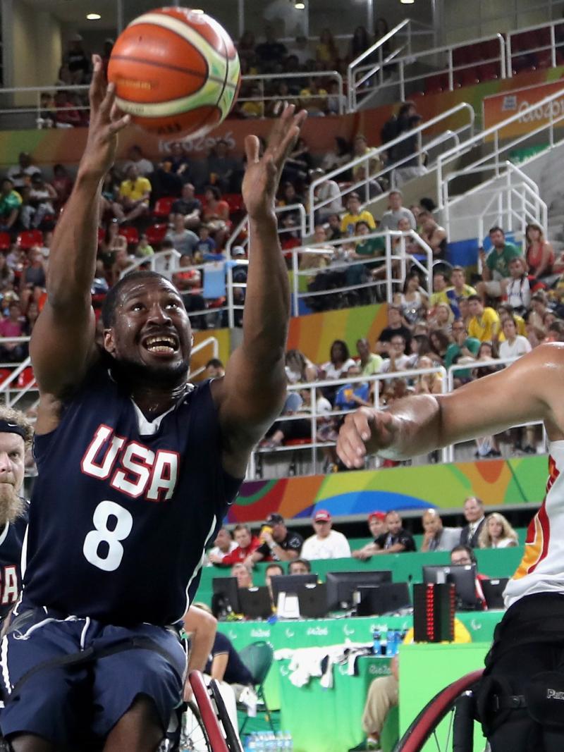 male wheelchair basketball players Alejandro and Pablo Zarzuela challenge a US player for the ball