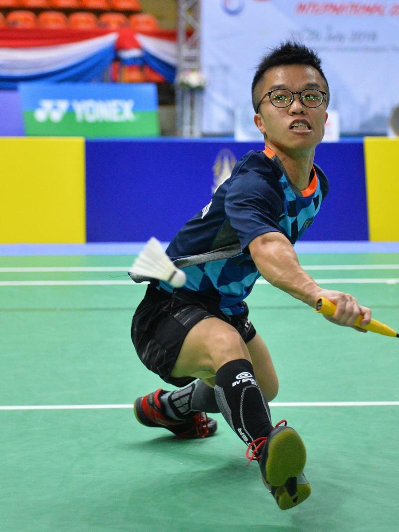 male Para badminton player Wong Chun Yim goes to hit a backhand