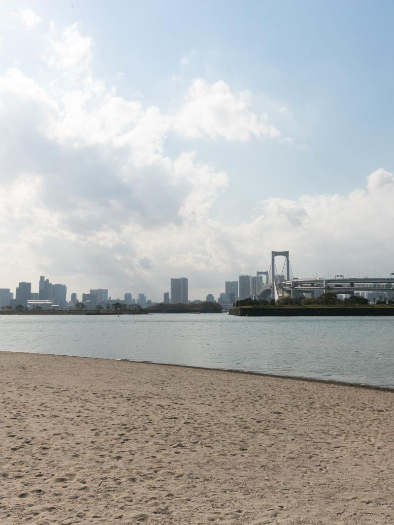 a wide shot of the beach and bay at Odaiba Marine Park in Tokyo