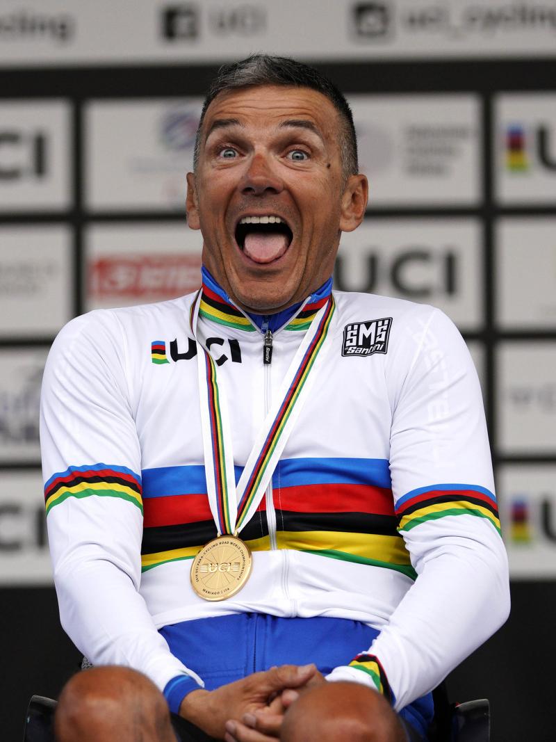 Fabrizio Cornegliani celebrates on the podium with a big smile