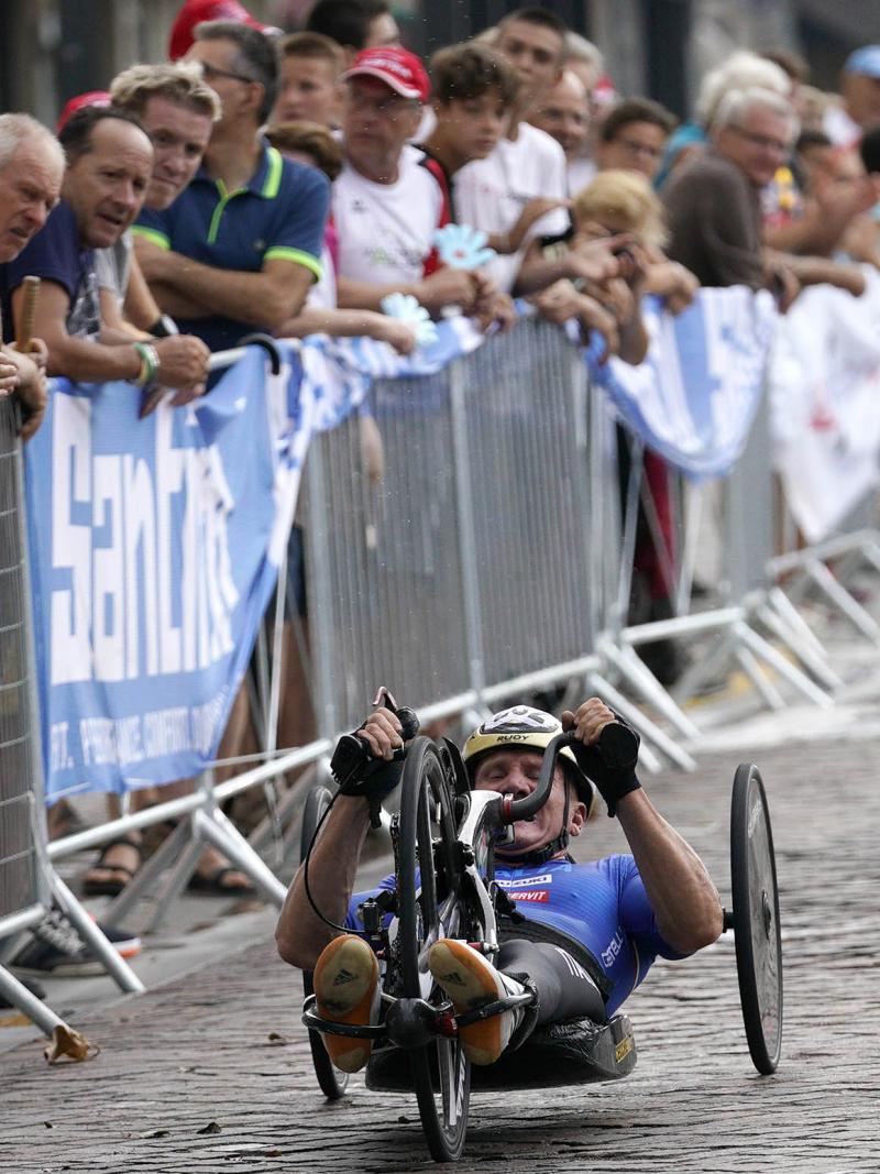 male Para cyclist Fabrizio Cornegliani riding a handbike on a road
