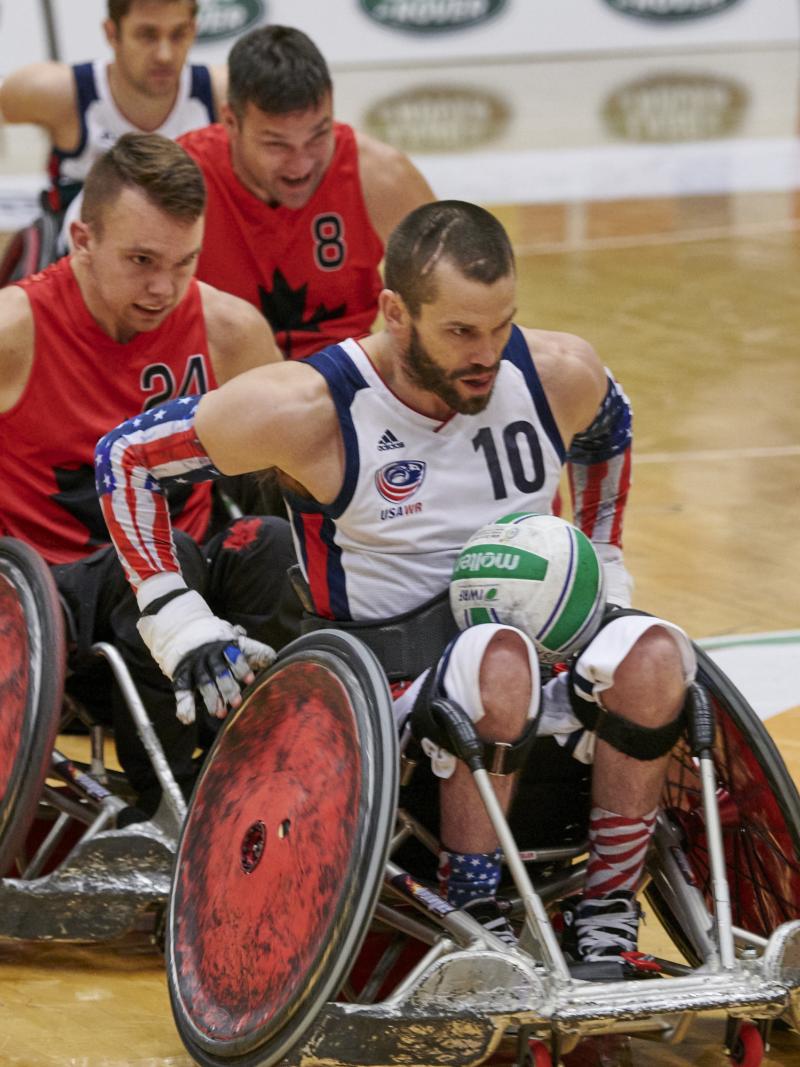male wheelchair rugby player Josh Wheeler of USA sprints away with the ball