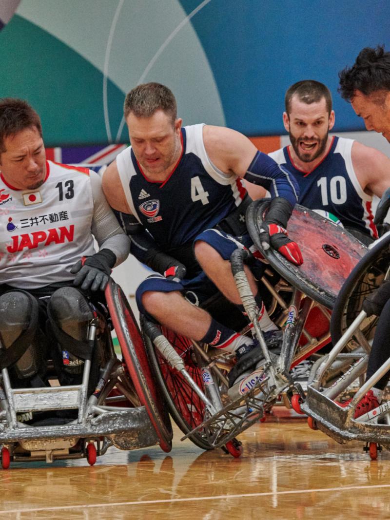 male wheelchair rugby players from USA and Japan clash on the court