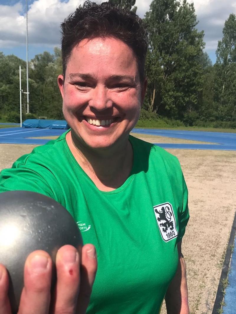 female Para athlete Birgit Kober smiling and holding a shot put