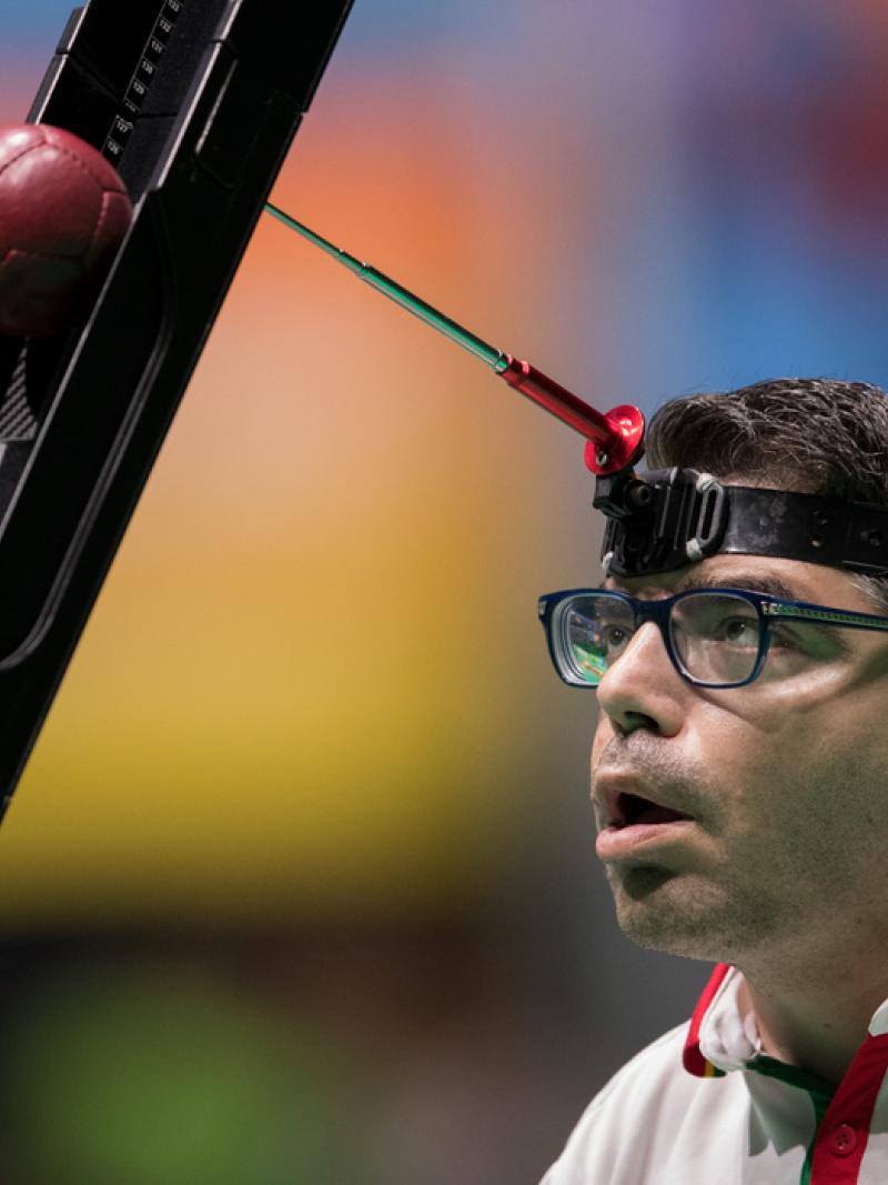 male boccia player Jose Macedo prepares to take a shot
