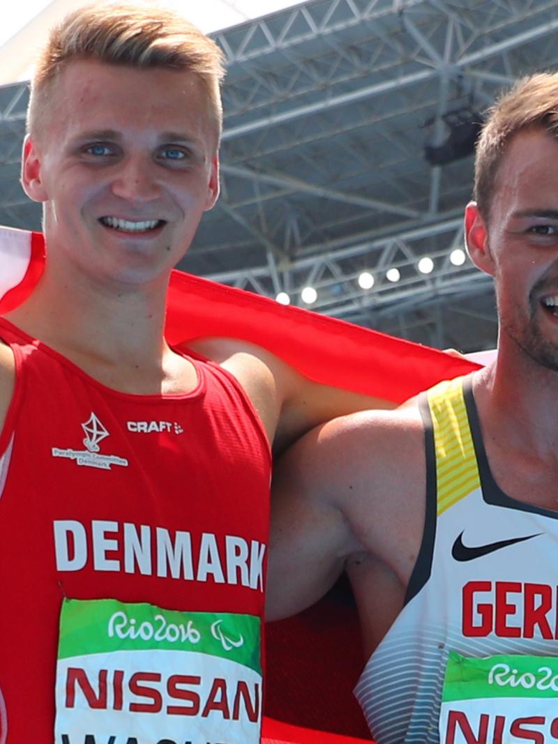 male Para athletes Daniel Wagner and Heinrich Popow smiling with their arms around eachother