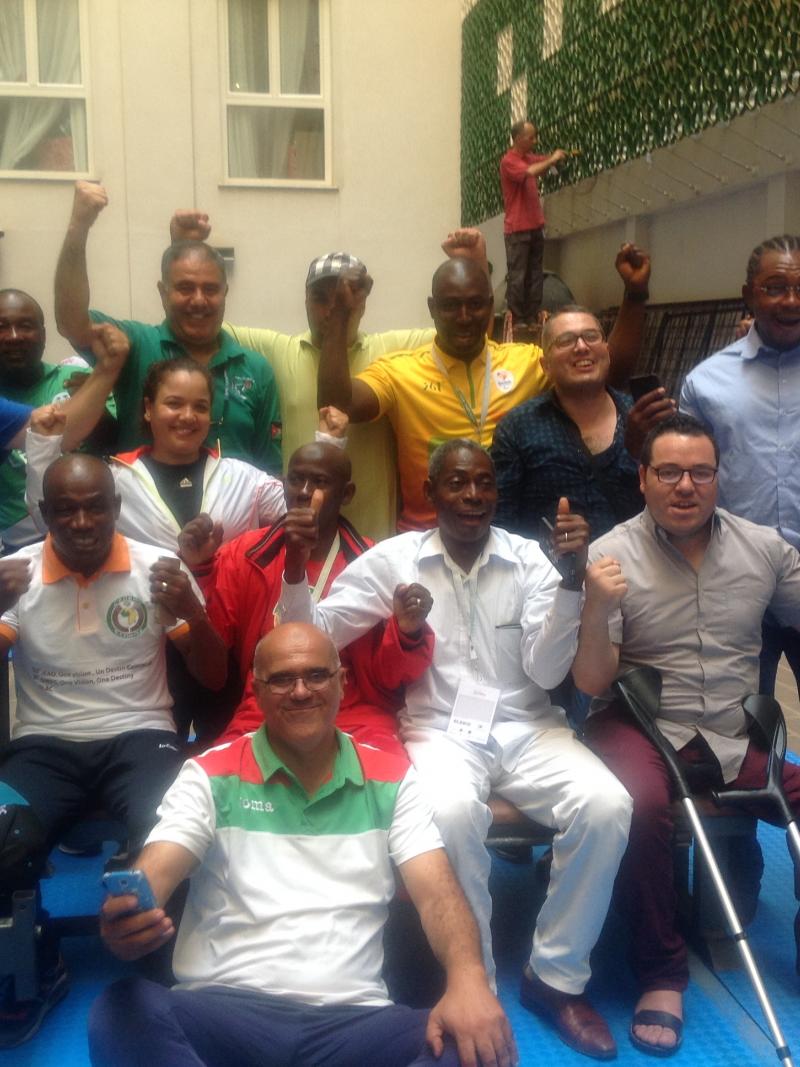 a group of African powerlifting officials smile for the camera