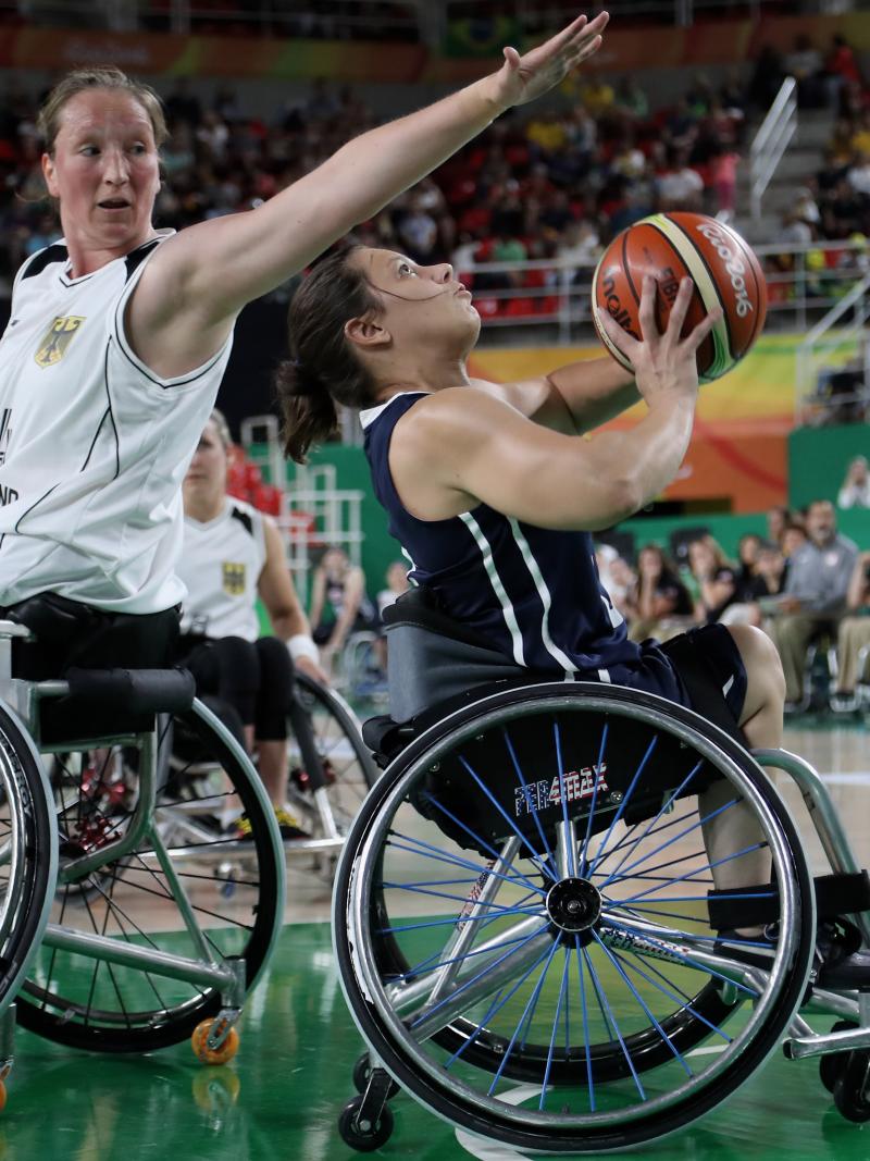 female wheelchair basketballer Marina Mohnen reaches over another player to block the ball