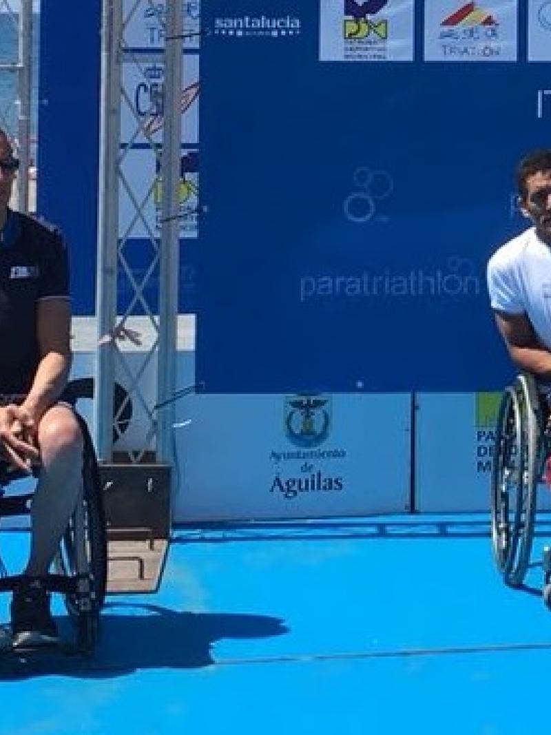 male Para triathletes Alexandre Paviza and Ahmed Andaloussi sitting on the podium
