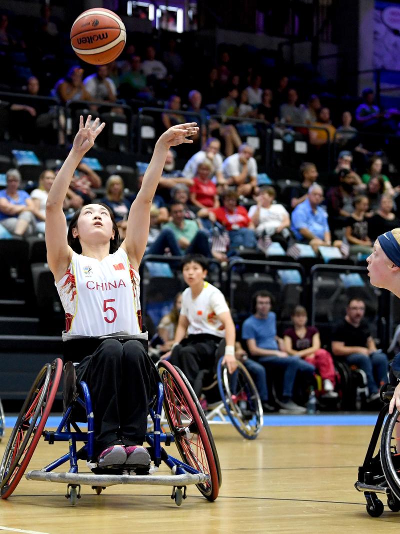 female wheelchair basketballer Xuemei Zhang challenges for the ball