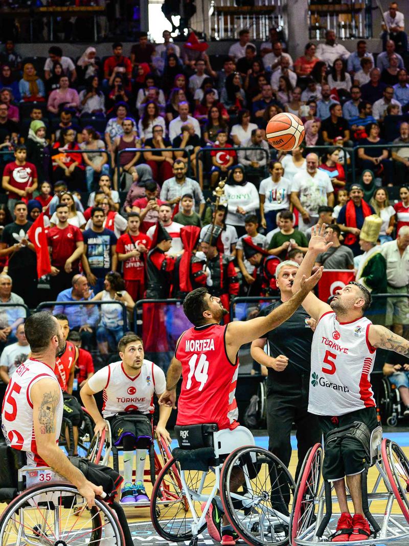 Male wheelchair basketballers Morteza Ebrahimi and Ozgur Gurbulak fight for the ball