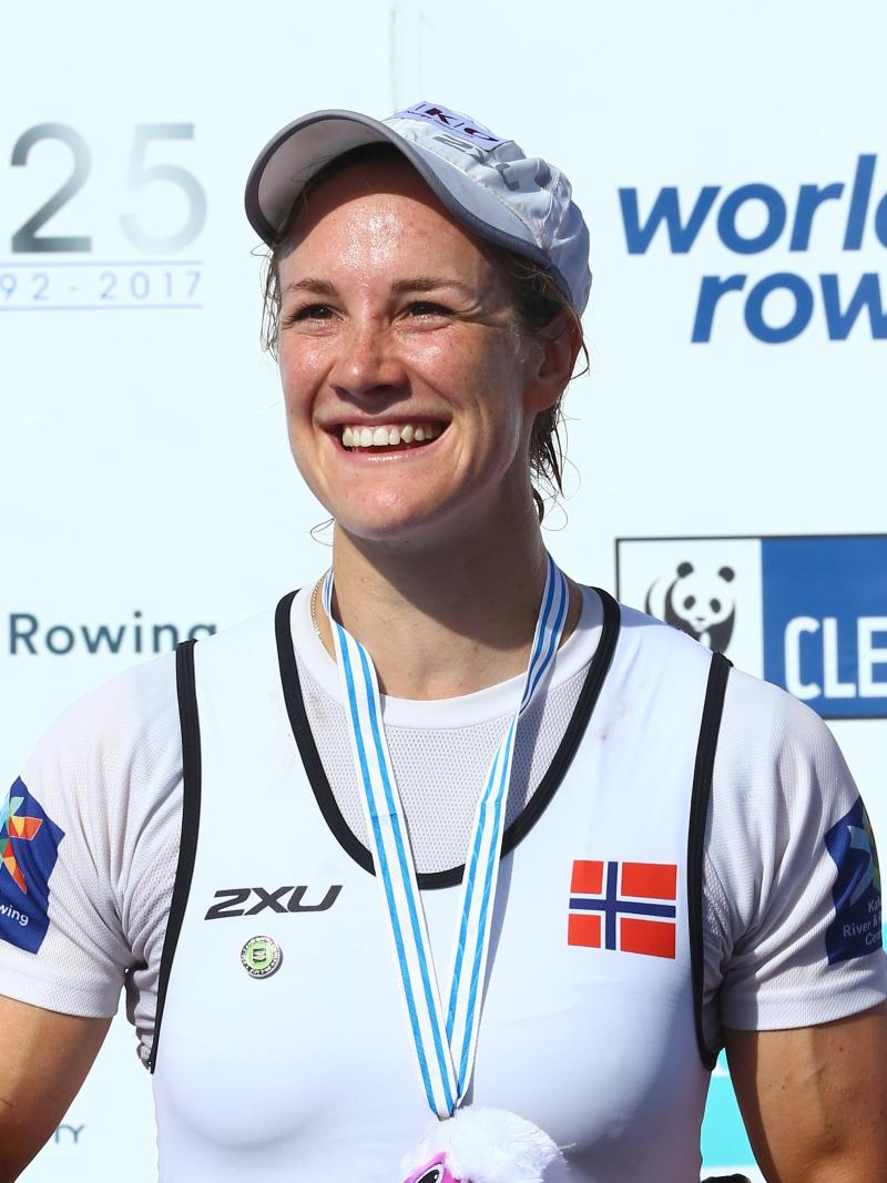 female Para rower Birgit Skarstein smiling with her medal on the podium