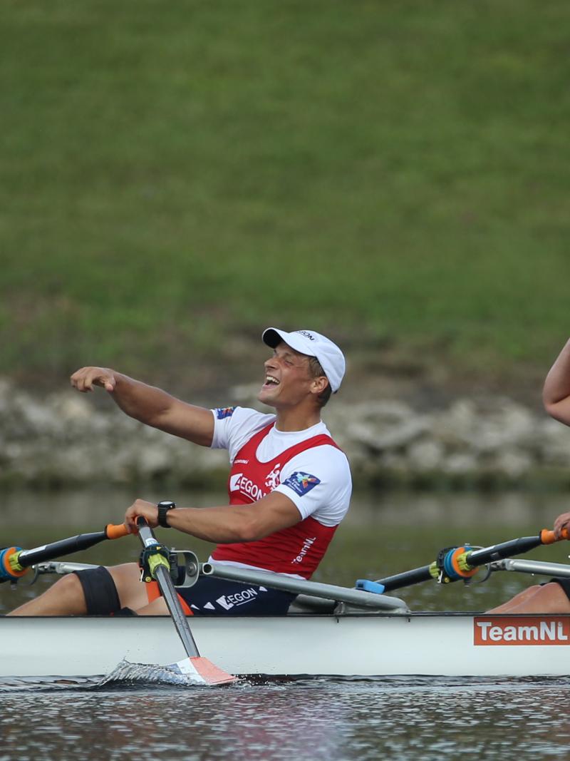 female and male Para rower Annika van der Meer and Corne de Koning celebrate in their boat