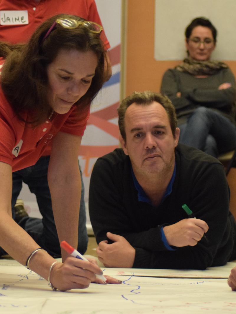Representatives from Latin American NPCs work on a tarks during a marketing and communications workshop in Bogota
