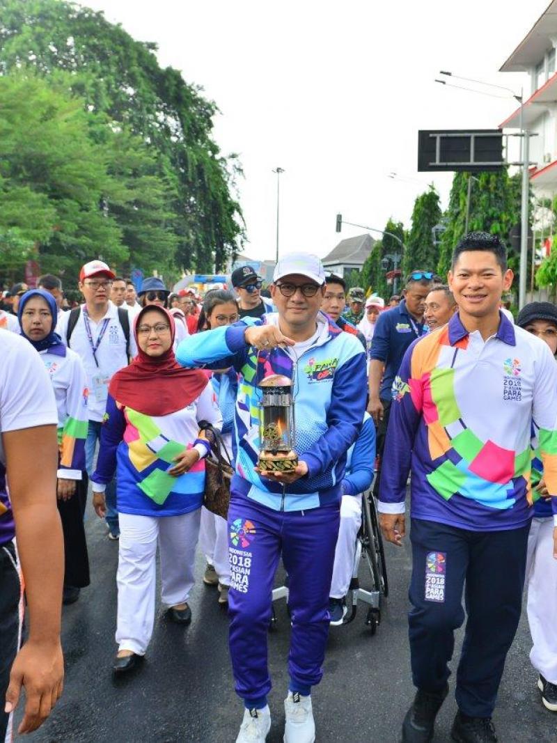 People marching together for a torch relay lighting ceremony