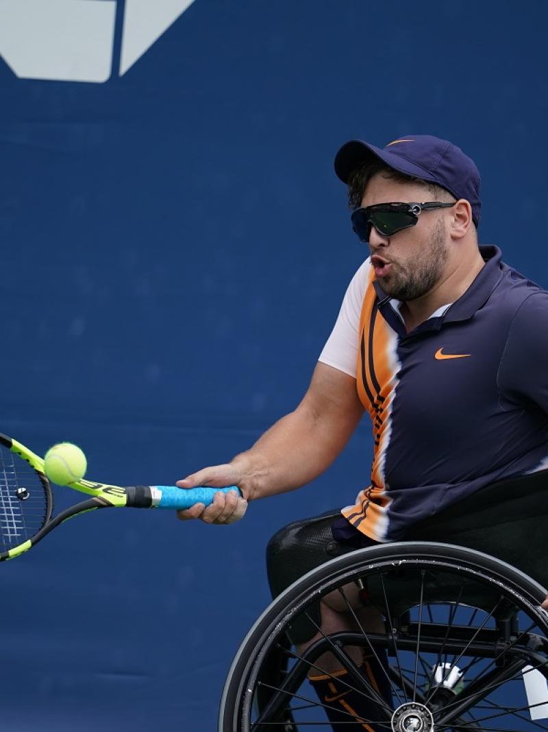 male wheelchair tennis player Dylan Alcott hits a forehand