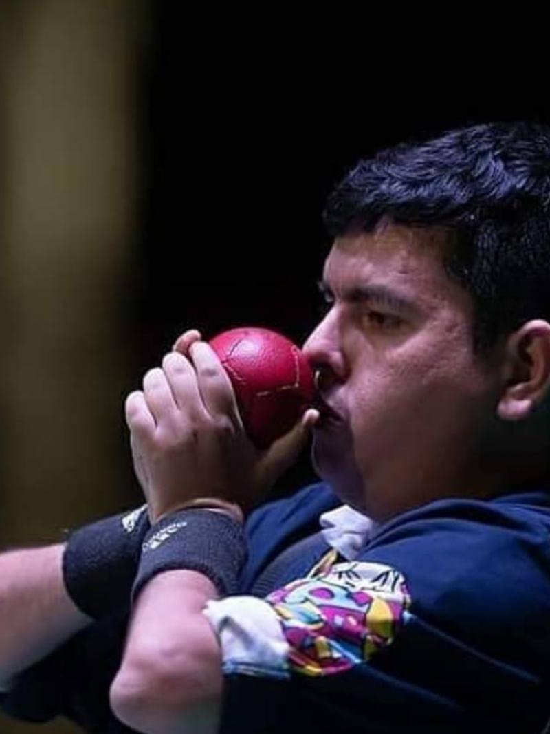 male boccia player Euclides Grisales prepares to throw the ball