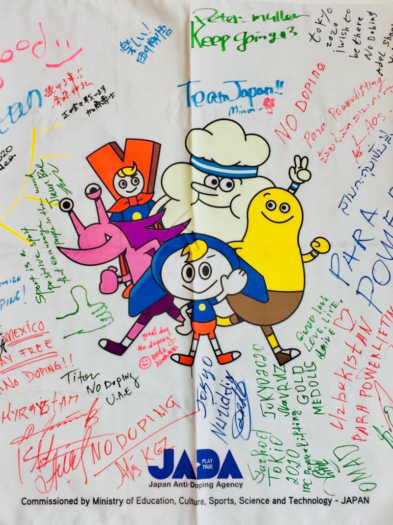 a flag from the Raise the Bar anti-doping programme covered with signatures 
