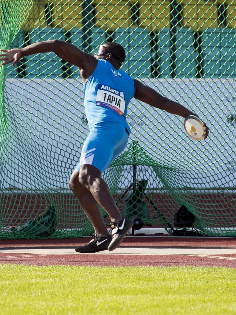 male Para athlete Oney Tapia prepares to throw a discus