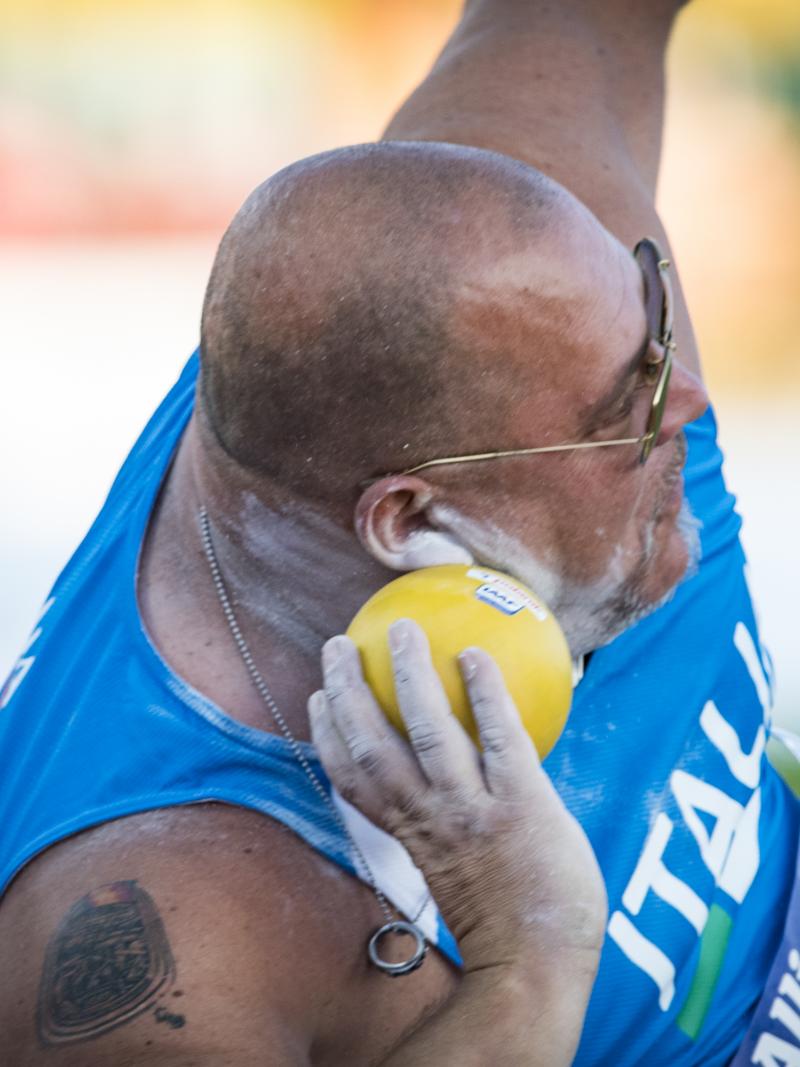male Para athlete Giuseppe Campoccio prepares to throw a shot put