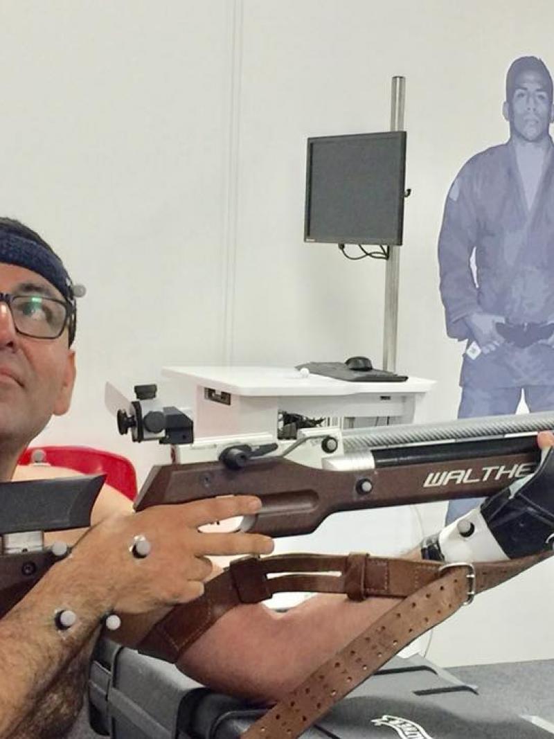 Man in a wheelchair holding a rifle