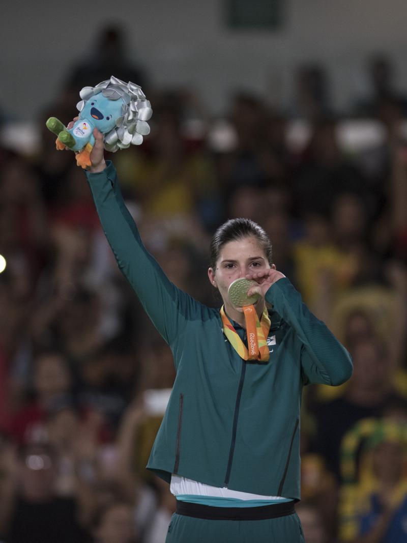 Woman kisses her medal