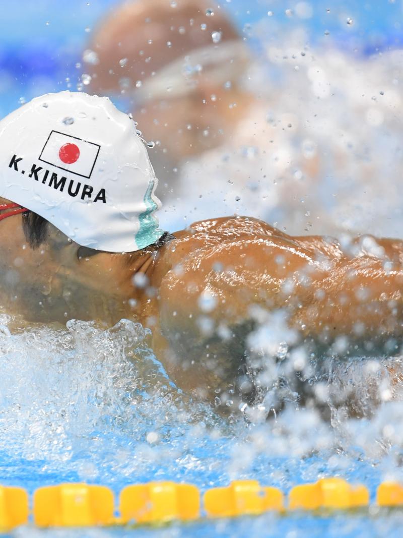 Man swimming with a cap showing the Japanese flag
