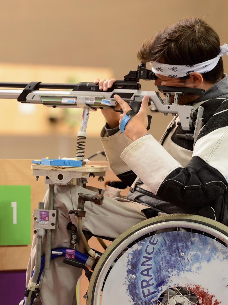 Man in a wheelchair shooting a rifle