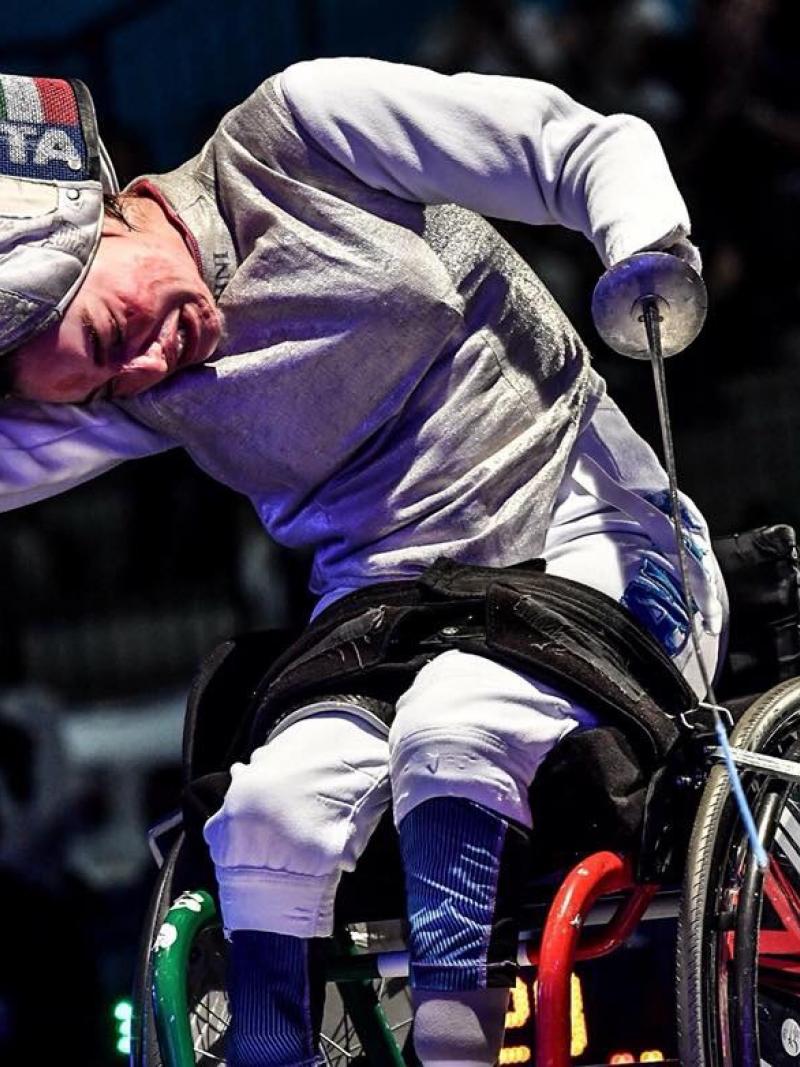 Italian female wheelchair fencer takes off her mask after a win