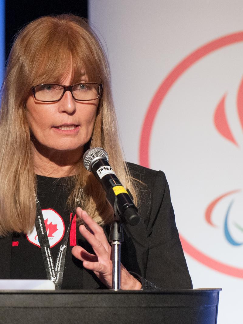 female chief executive Karen O’Neill speaking at a podium