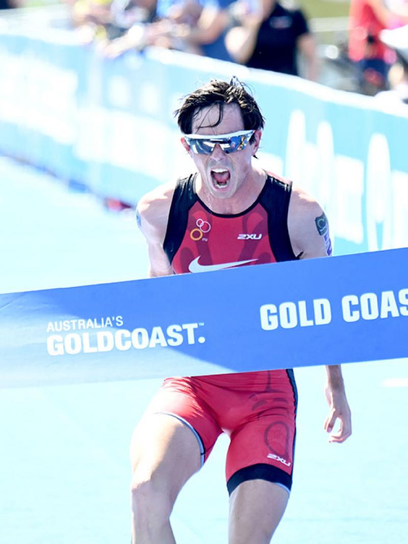 Para triathlete celebrates when crossing the line